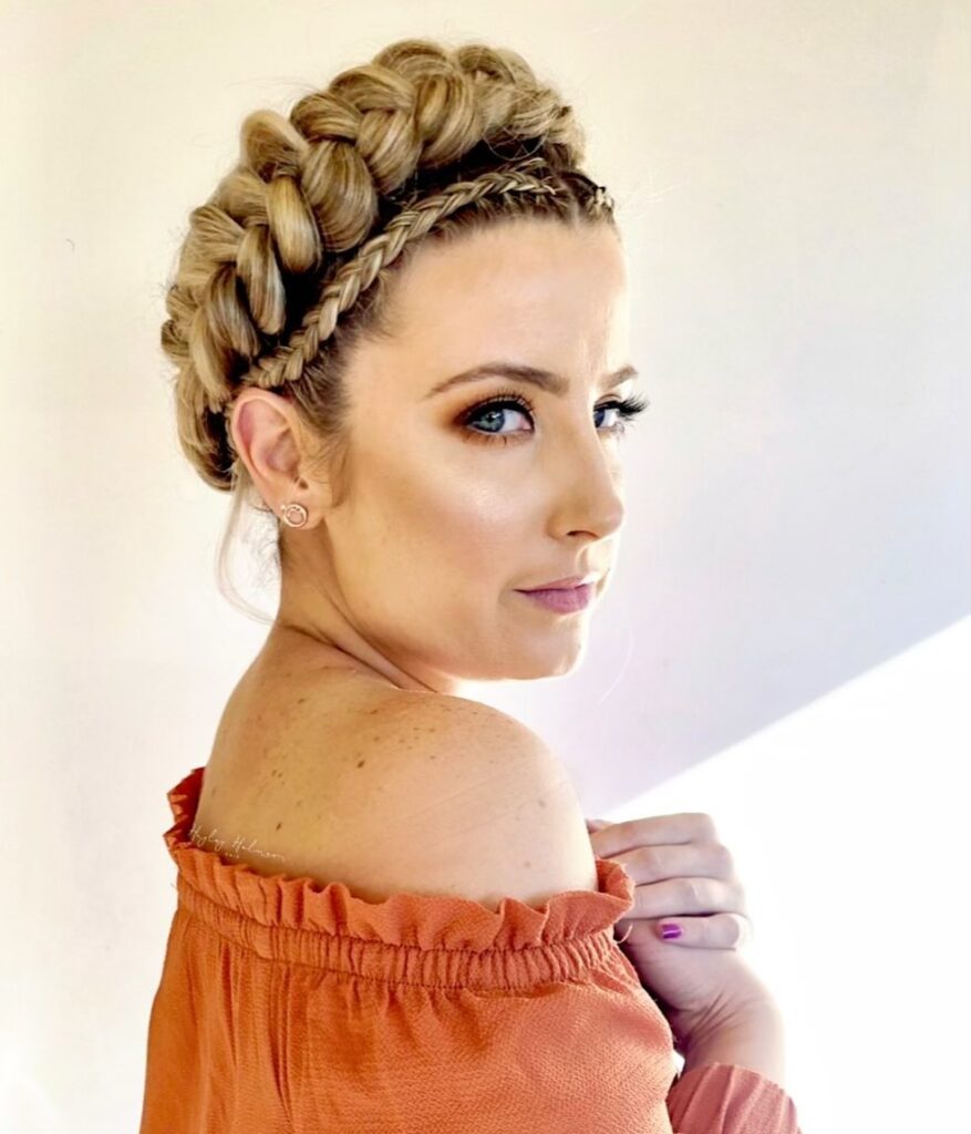 Blonde braided crown updo with a chunky braid and smaller accent braid around the head.