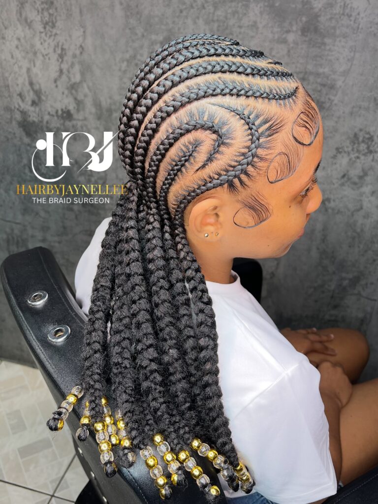 Tribal style braids with intricate scalp patterns and long braids finished with gold and clear beads.