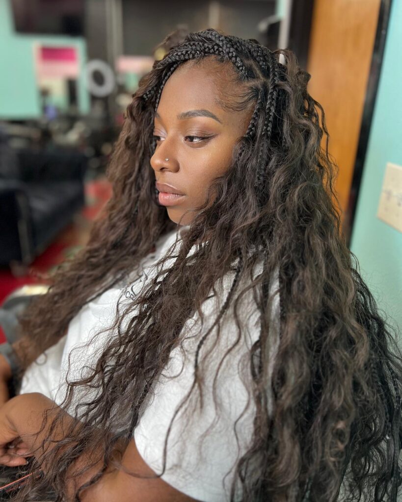 Island braids with small side braids at the front and long loose wavy hair.
