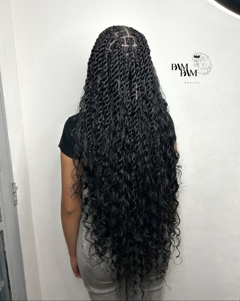 Long black island braids with medium sections and voluminous curly ends.