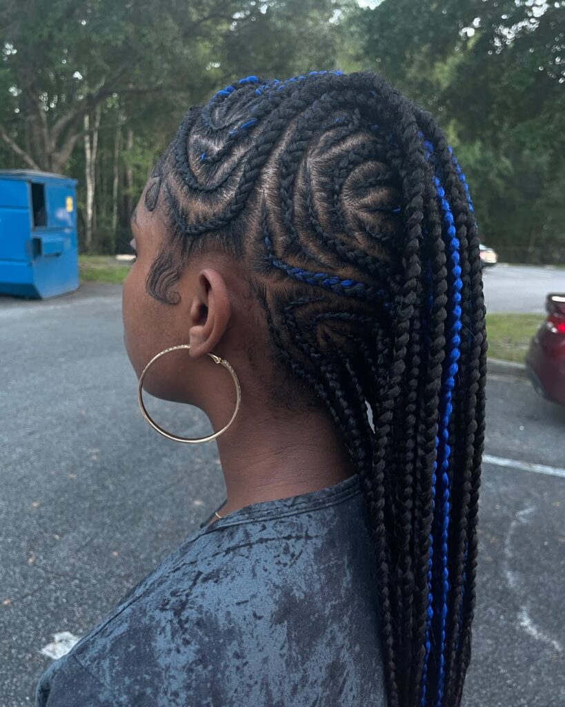 Long box braided mohawk with cornrow sides and blue highlight accents.
