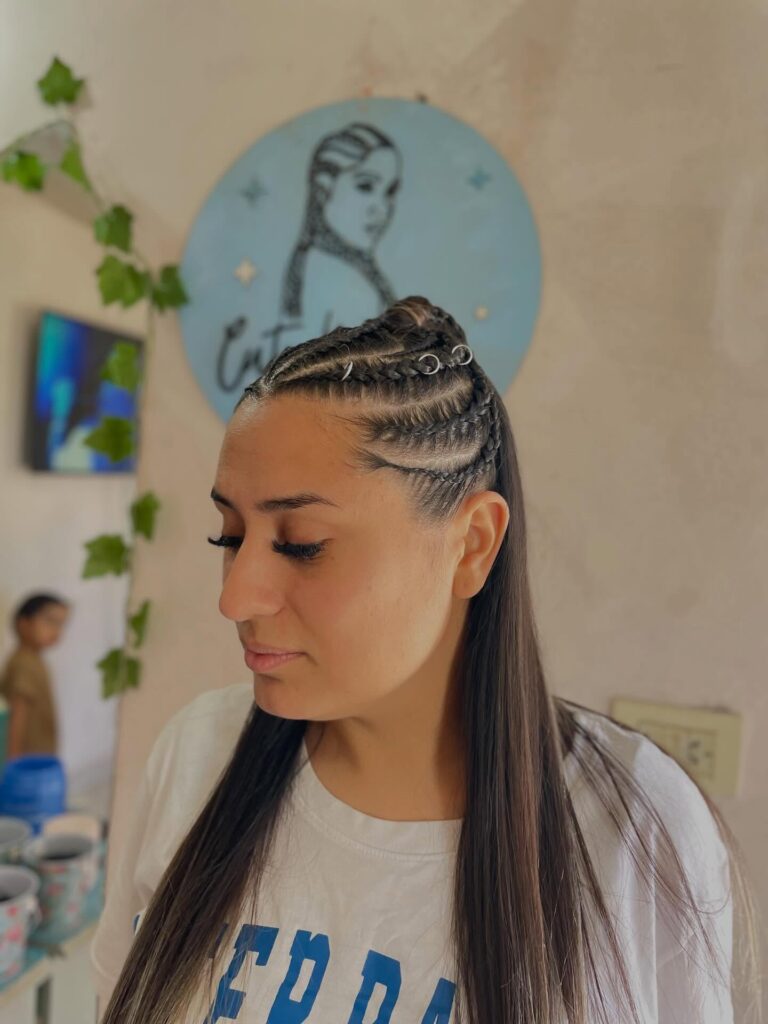 Side cornrow braids blended into long straight hair with a sleek finish.
