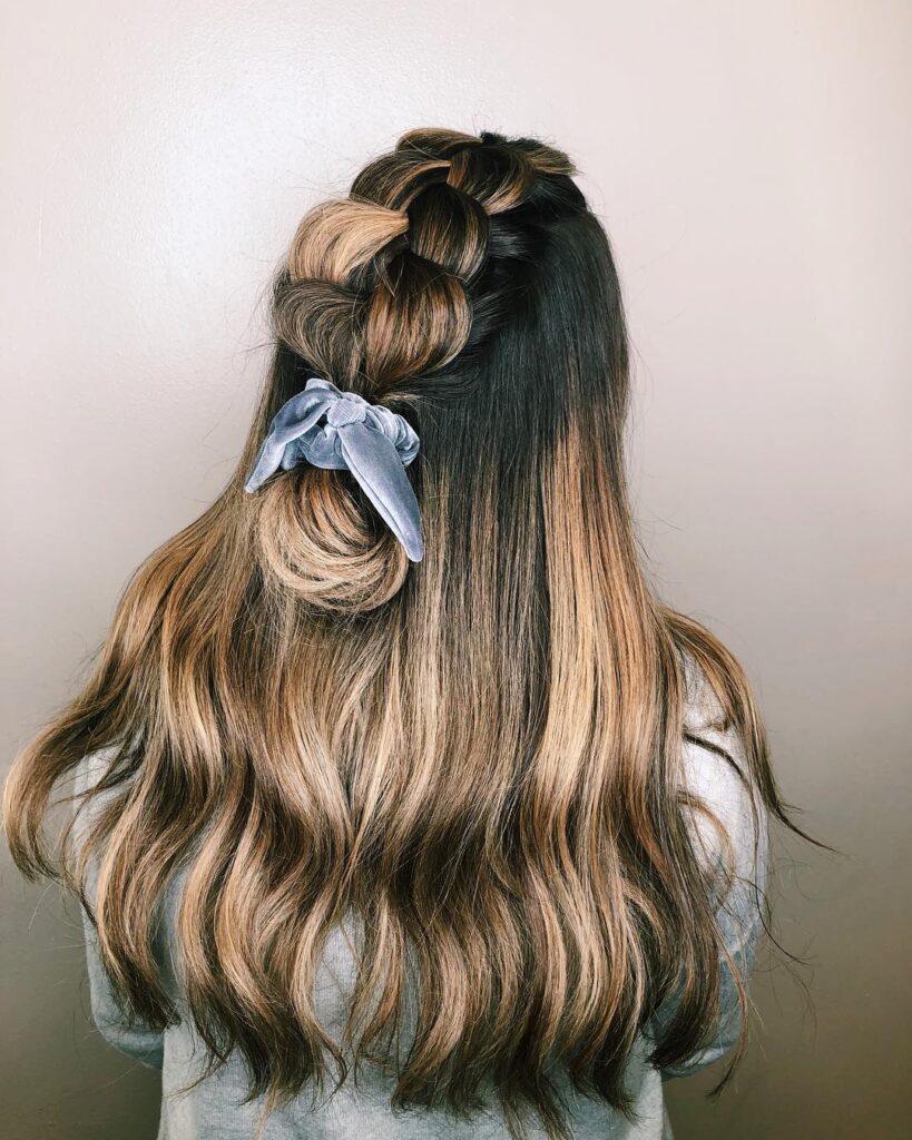 Chunky pull through braid with blonde highlights tied at the end with a ribbon.