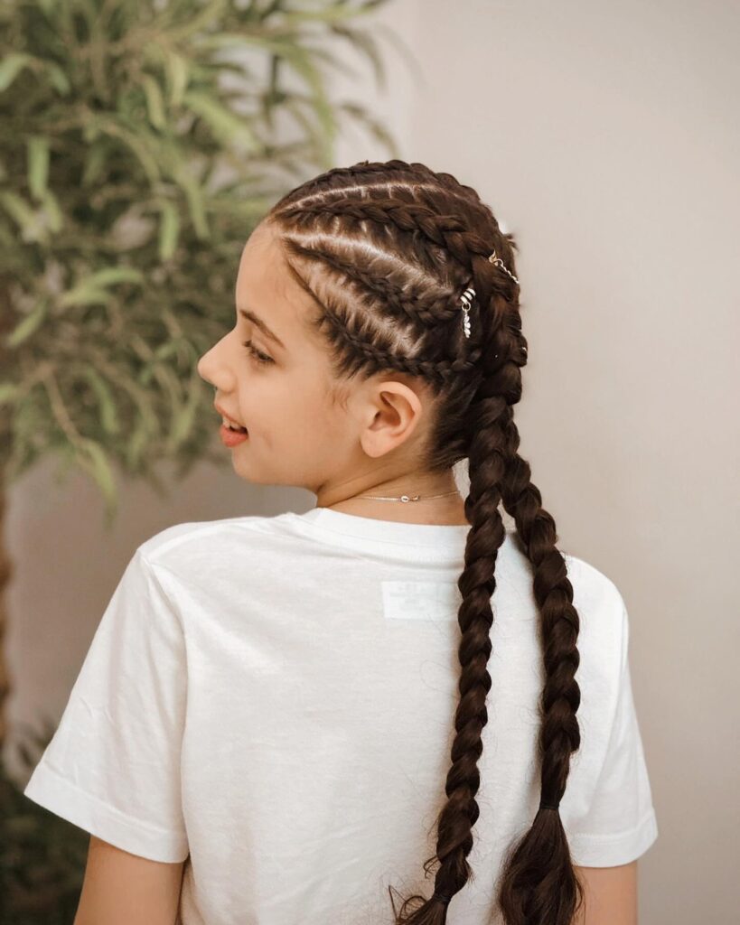 Two neat Dutch braids styled symmetrically from front to back on straight hair.