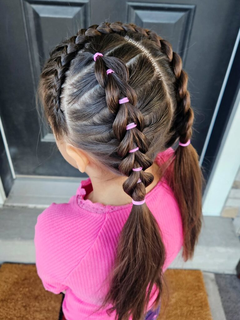 Two side braids with a center bubble braid tied with pink elastics.