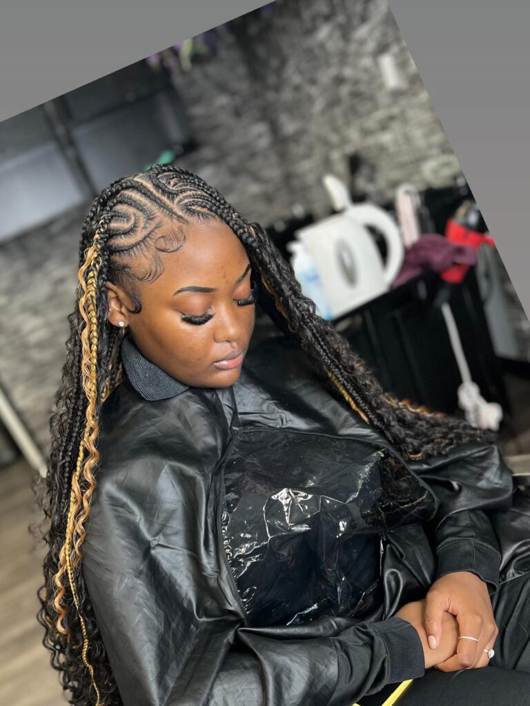 Side parted braids with detailed scalp patterns and subtle blonde highlight strands.