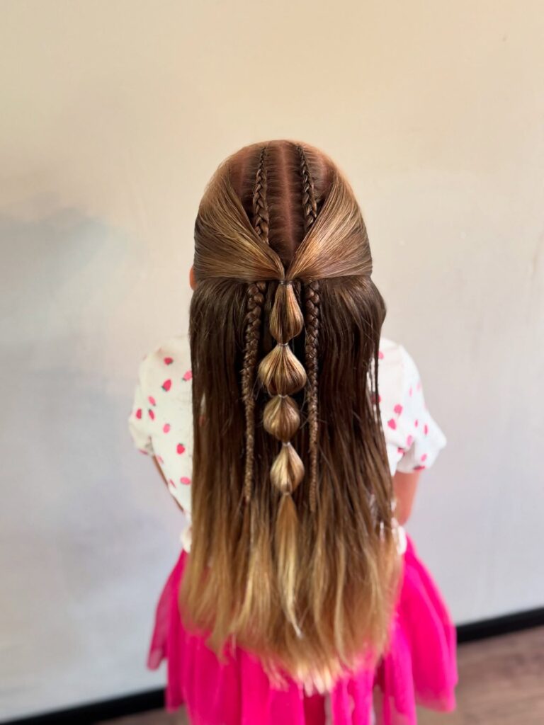Half up hairstyle with small braids and a central bubble braid on straight hair.
