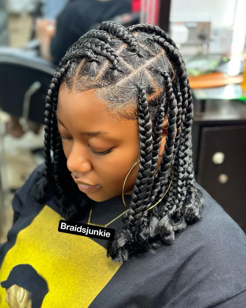 Short chunky knotless braids styled into a bob with softly curled ends.