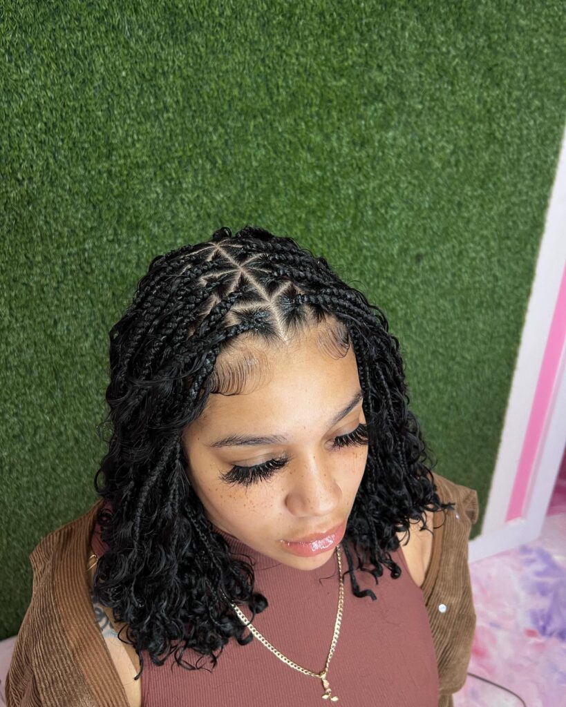 Short bob with neat box braids, defined parts, and curled ends.
