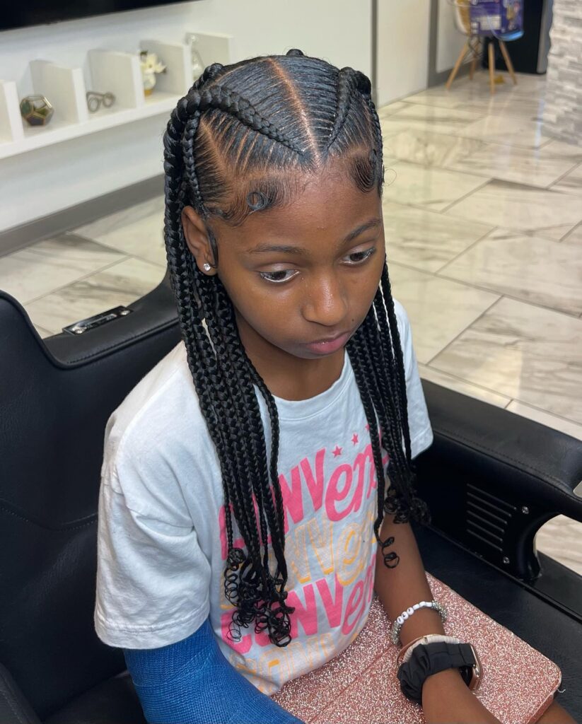 Black braided pigtails with heart shaped parts and curled braid ends.