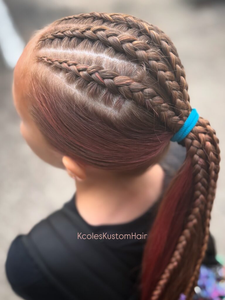 Smooth reddish brown hair styled with multiple scalp braids into a long braided ponytail.