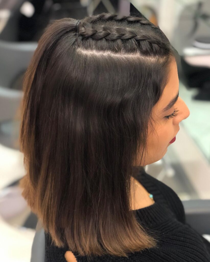 Shoulder length brunette bob styled with a chunky braid across the crown.