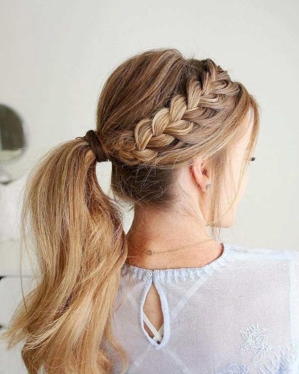 Blonde hair styled in a low ponytail with a thick side braid wrapped into the style.