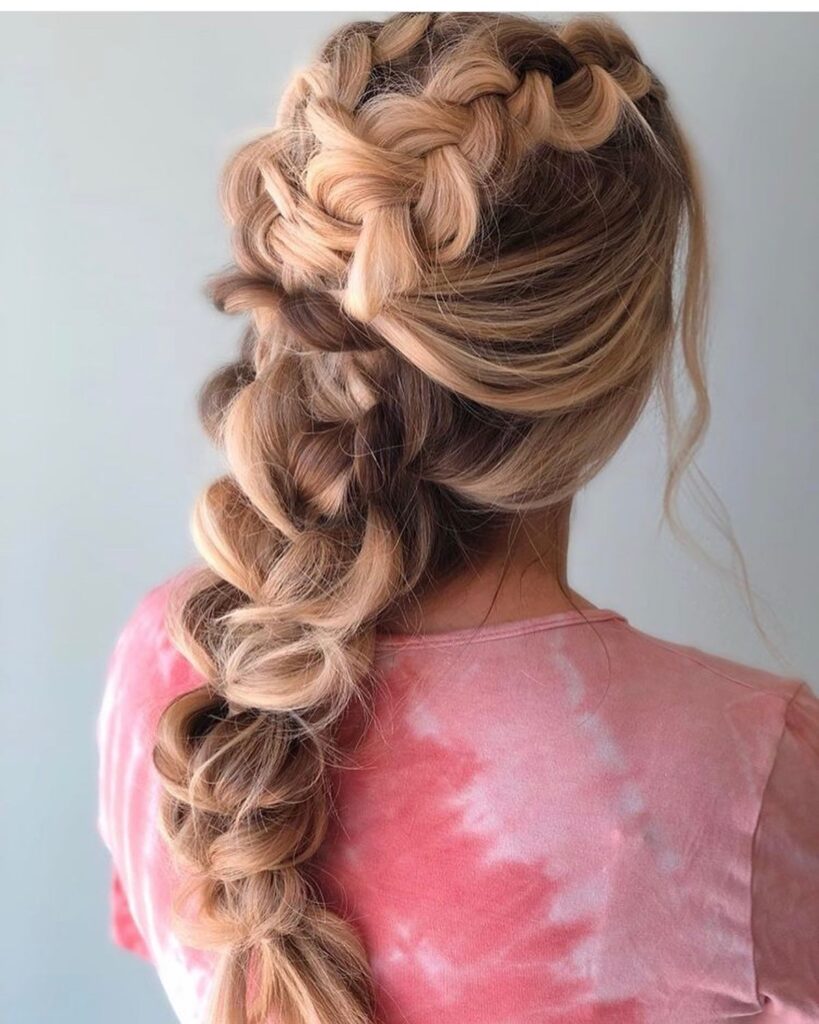 Large pull through braid with voluminous sections and soft blonde waves.