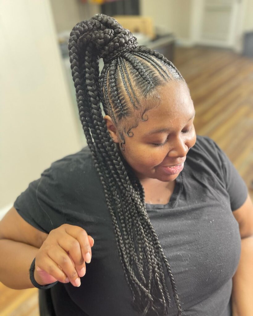 A high braided ponytail with long chunky braids and neat scalp braiding.
