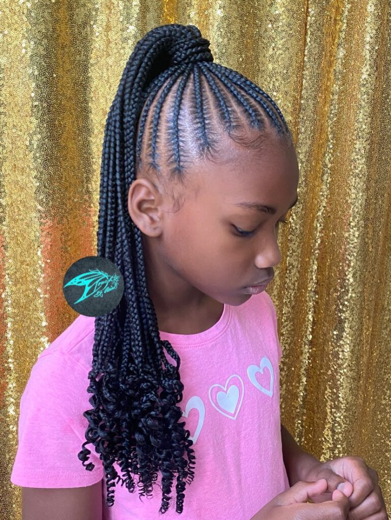 A high braided ponytail with skinny braids and curly ends.