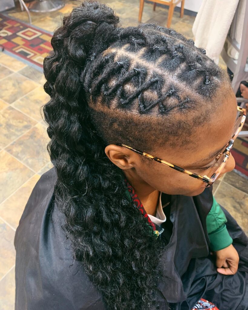 A braided ponytail with chunky twists and a long wavy black ponytail.