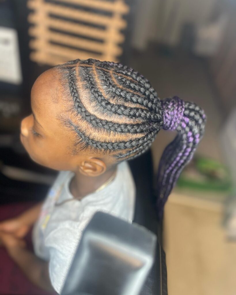 Curved cornrows styled into a high braided ponytail with black and purple braids.
