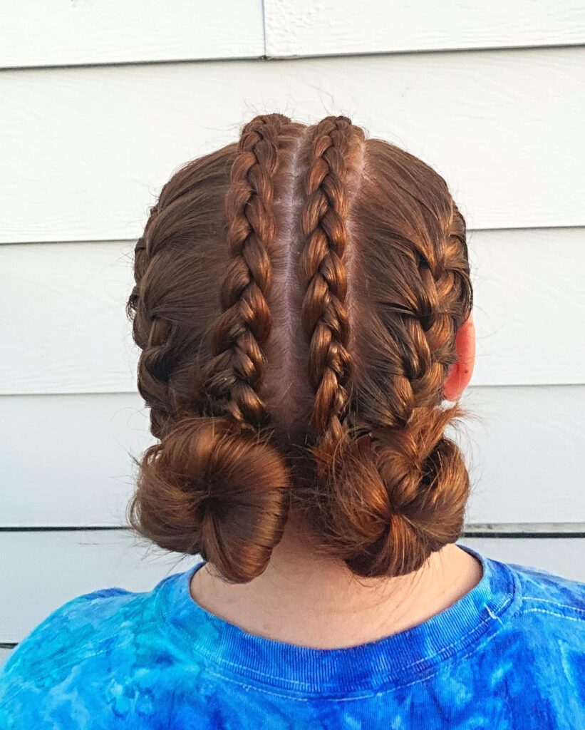 Back view of auburn braided space buns with neat cornrow details and twisted low buns.