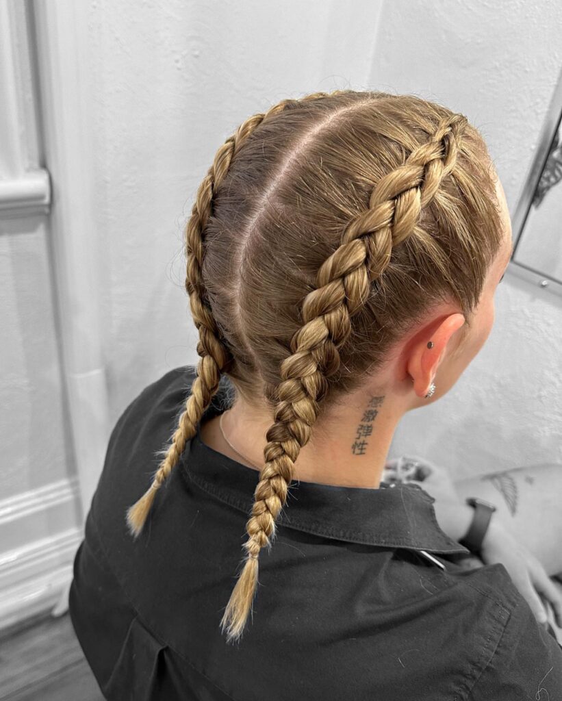 Back view of neat blonde Dutch braids with clean center parting and tight woven texture.