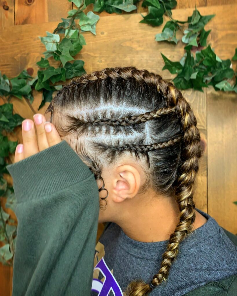 Side view of sleek cornrow braids with defined parts and a thick highlighted braid.