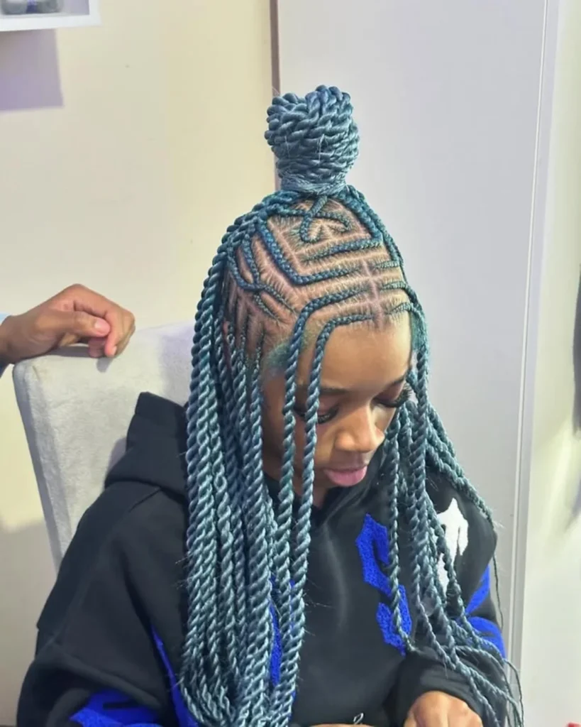 Blue rope twists with a top knot and geometric braided scalp design.