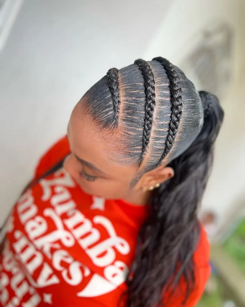 Sleek braided ponytail with three scalp braids and a long wavy ponytail.