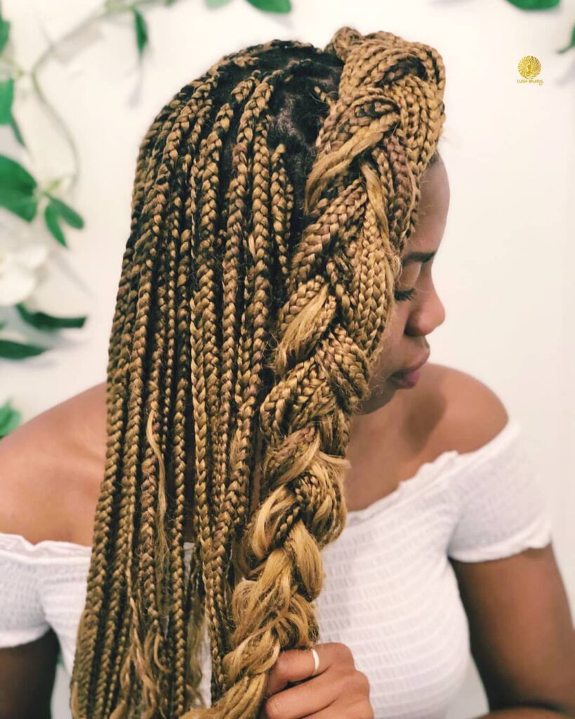 Chunky blonde box braids with neat square parts and thick uniform plaits.