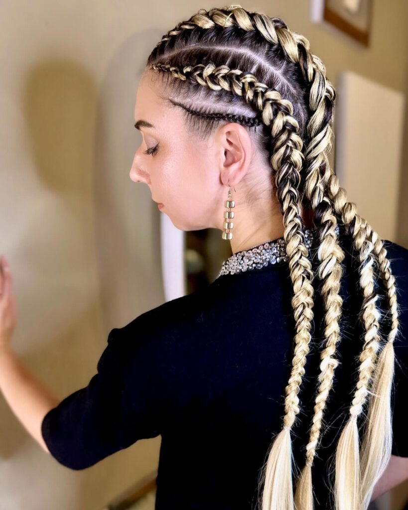 Blonde tribal braids with defined parting patterns and structured plaits.