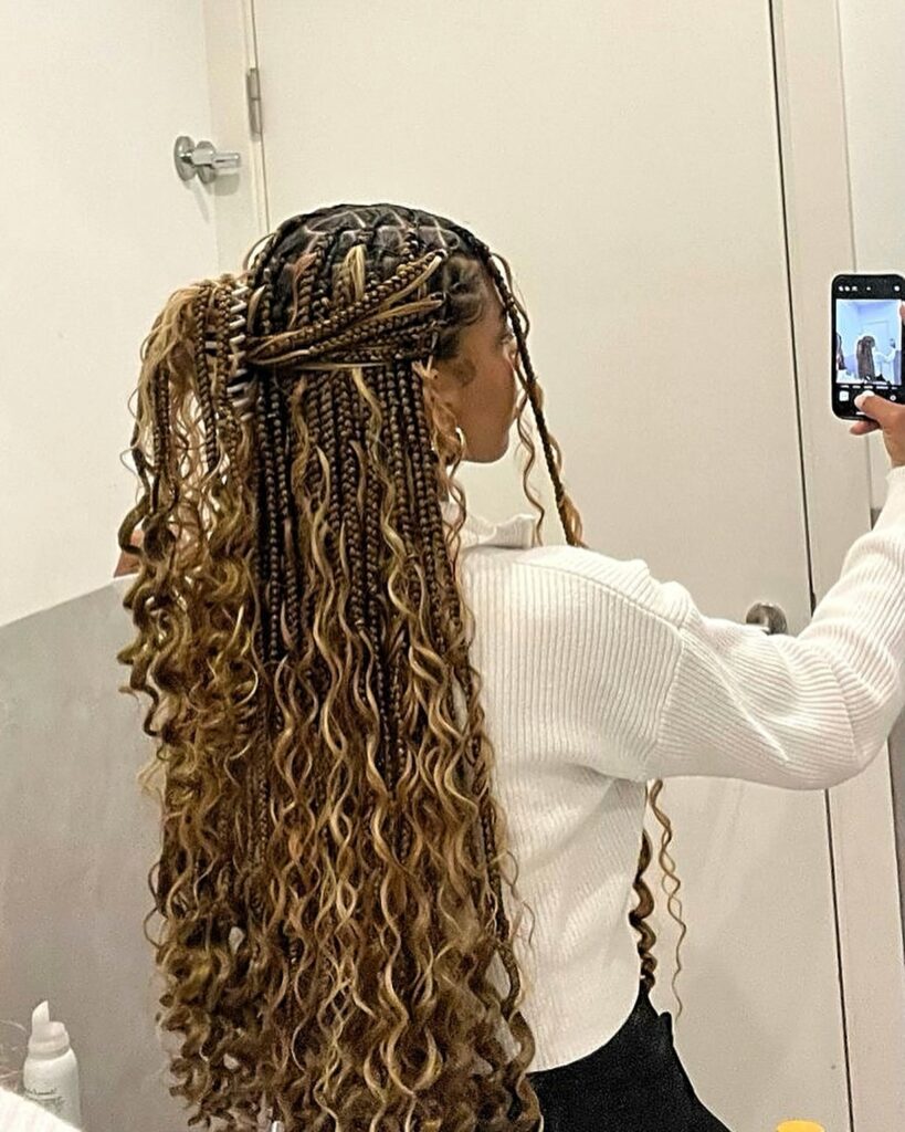 Half up blonde boho braids with curly lengths cascading down the back.