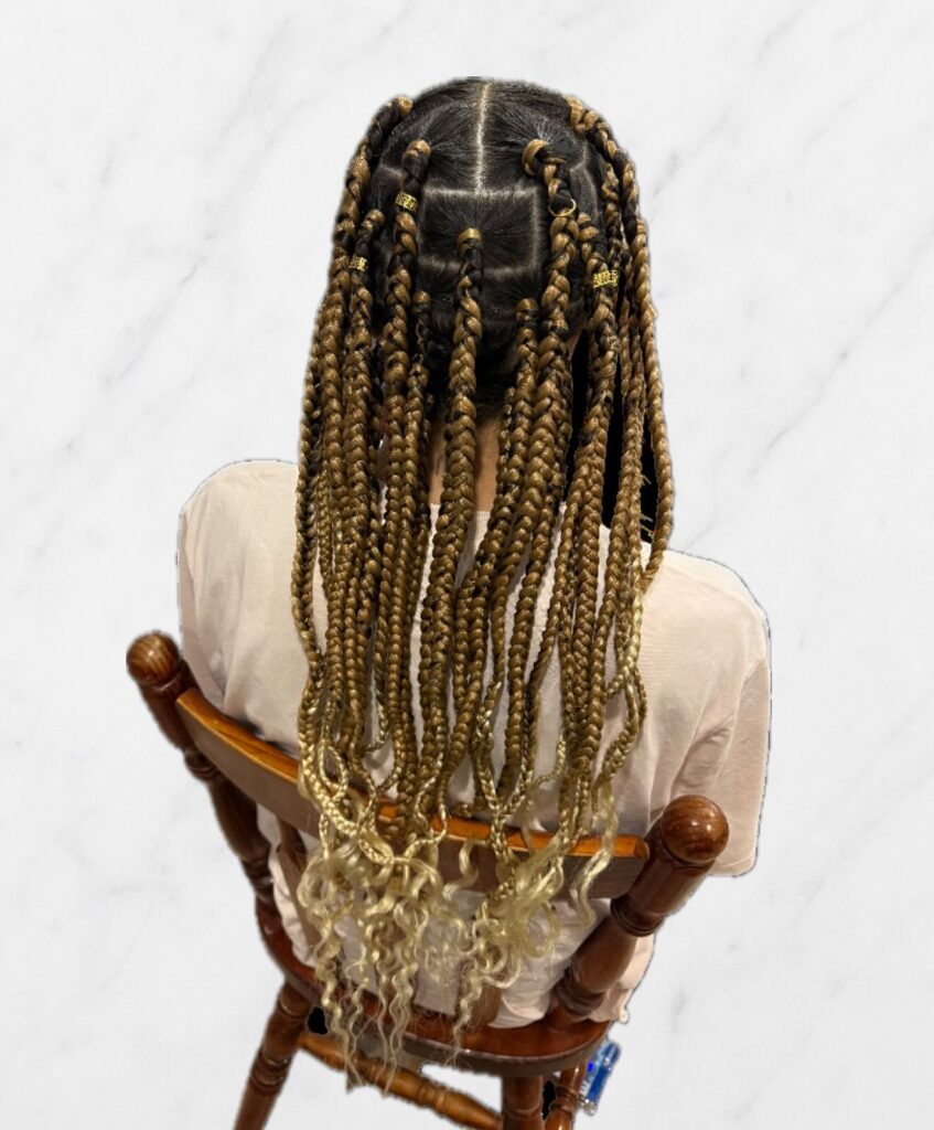Chunky blonde box braids with neat parts and loose curly ends at the bottom.