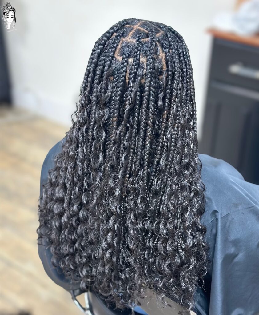 Medium knotless braids with full curly ends and voluminous texture.