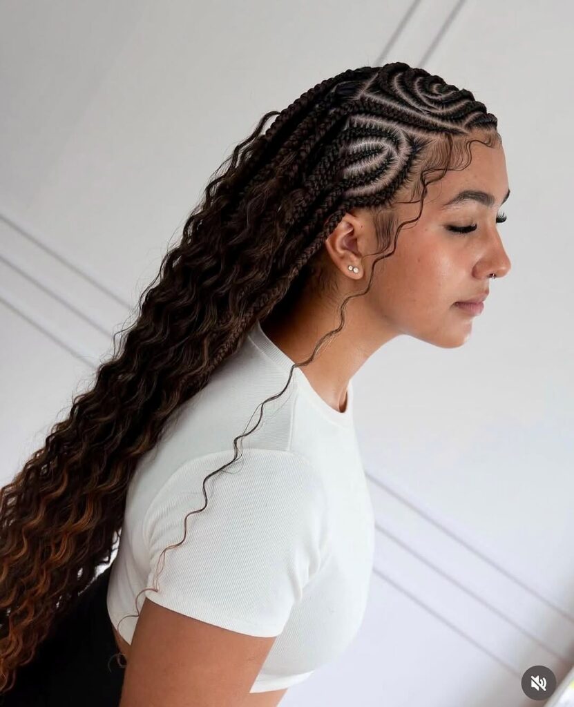 Boho knotless braids with spiral cornrow patterns and long loose wavy lengths.