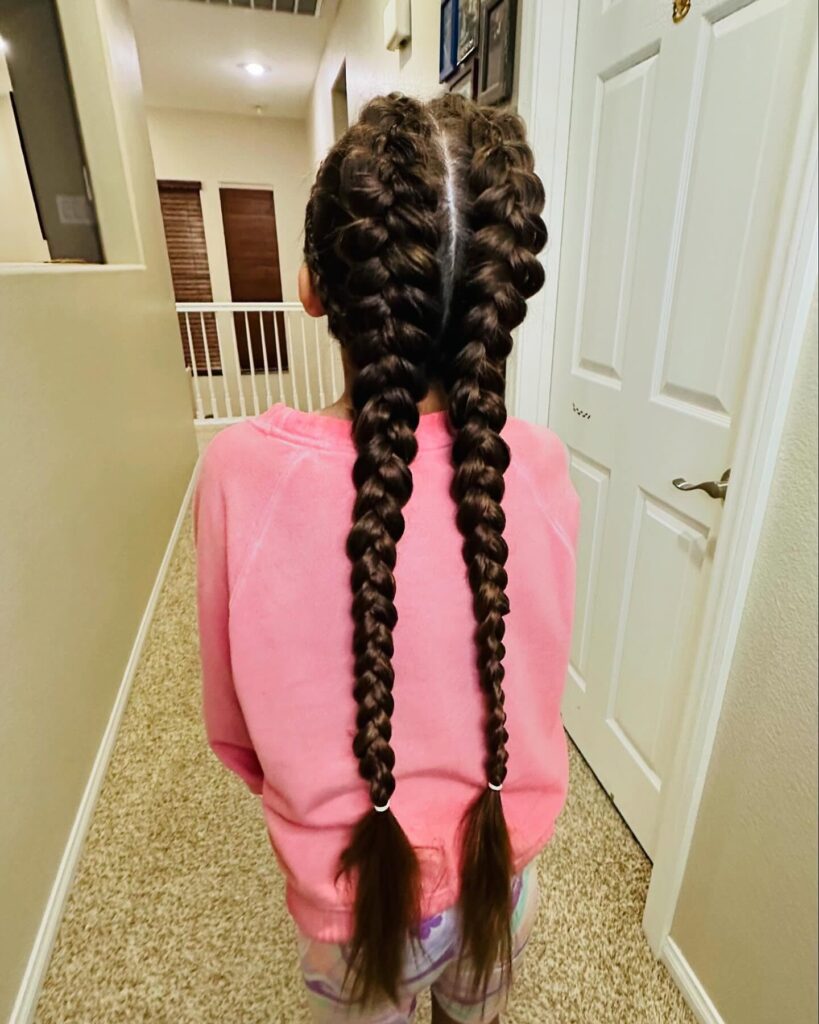 Extra long bubble braided pigtails with thick dark braid sections and sleek roots.