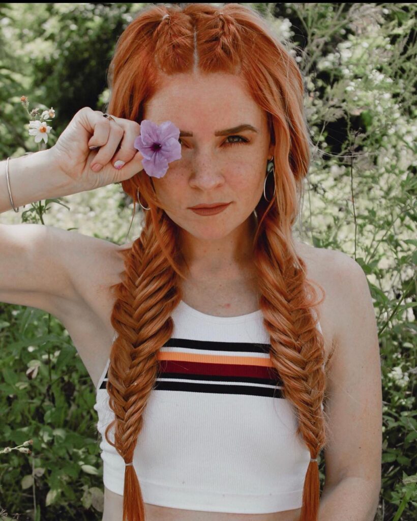 Ginger fishtail braided pigtails with soft texture and loose braided details near the top.