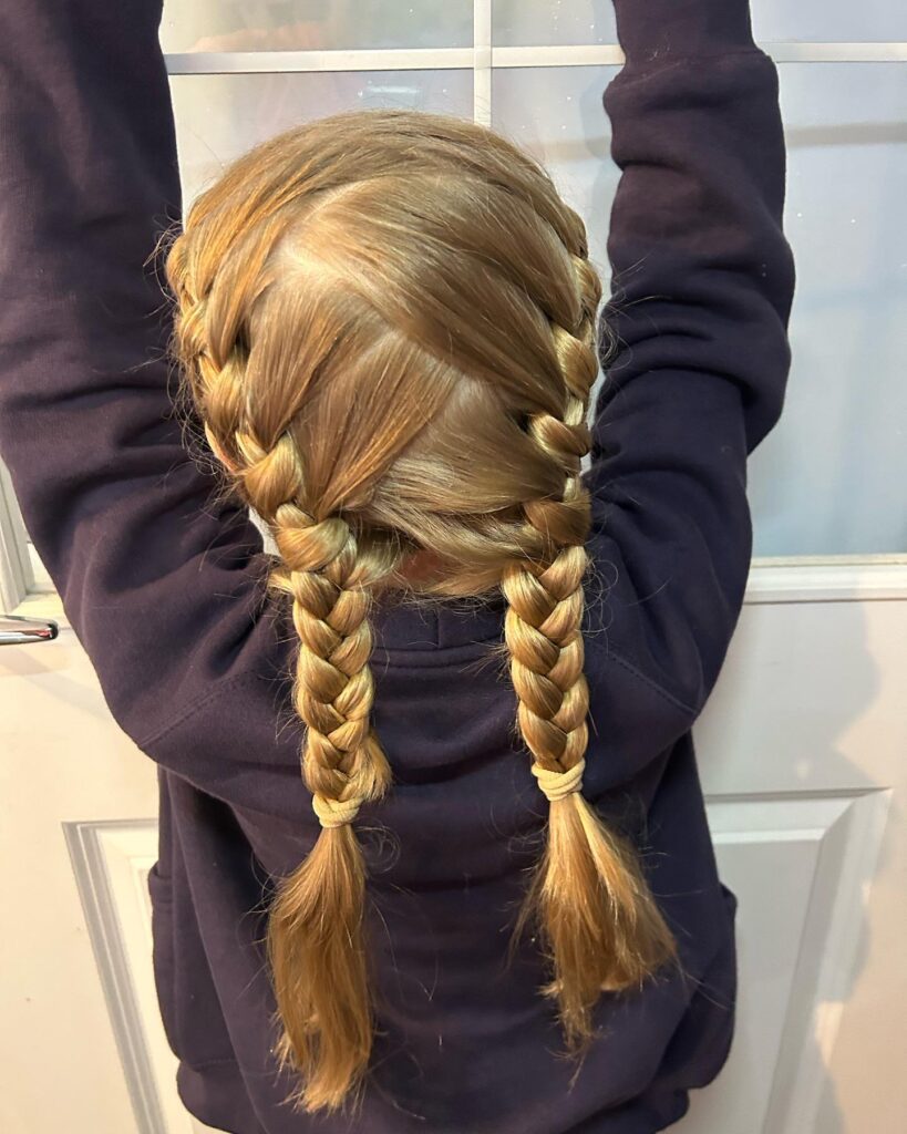 Classic blonde braided pigtails with neat woven braids and smooth sections.