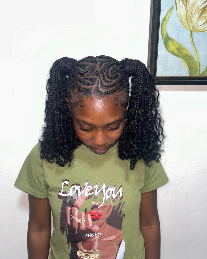 A woman with curly braided ponytails featuring swirl braid patterns and textured curly ends.