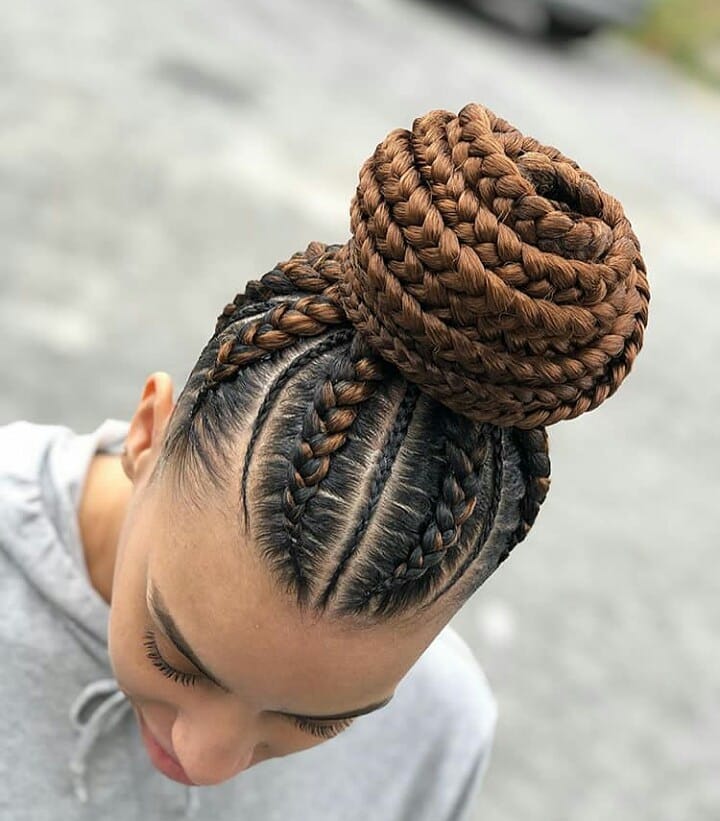 Large braided crown bun hairstyle with neat cornrows and chunky brown braids.