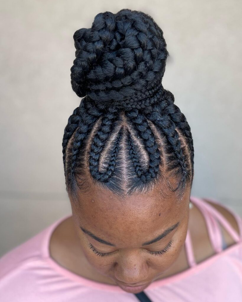 Chunky cornrow braided bun hairstyle with thick braids styled into a large top bun.