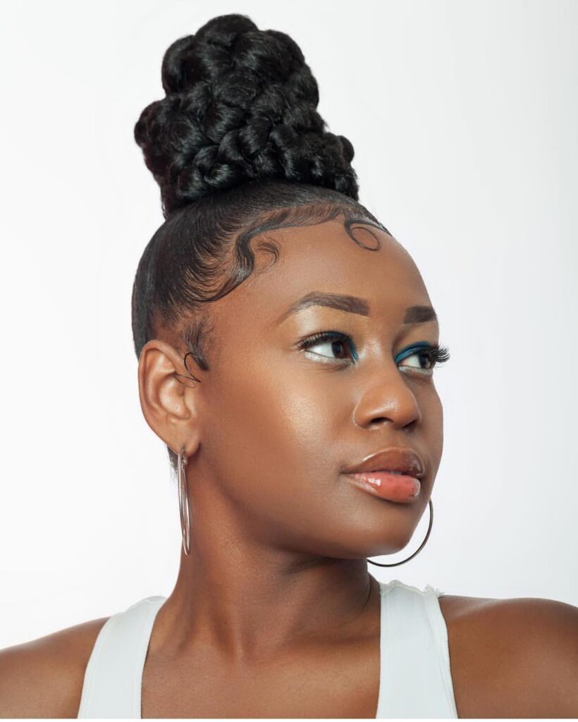 High braided bun hairstyle with sleek edges and a chunky braided top knot.
