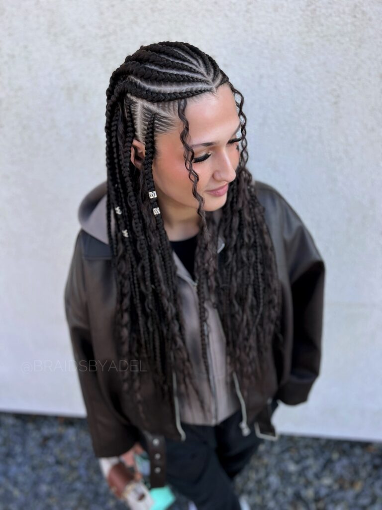 Fulani braids with long lengths and soft curls framing the face.