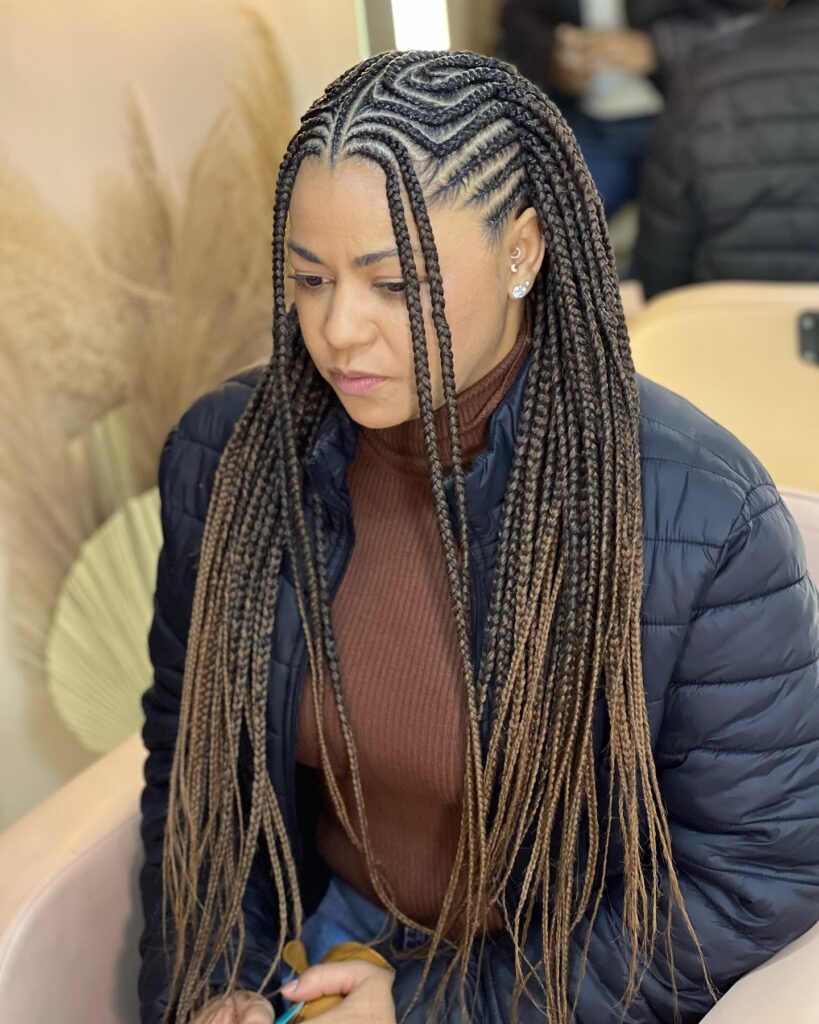 Fulani braids with a detailed swirl cornrow pattern and long straight lengths.