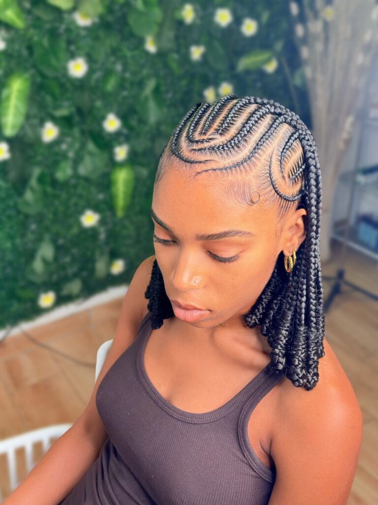 Fulani braids with wave style cornrow pattern and medium length braids.