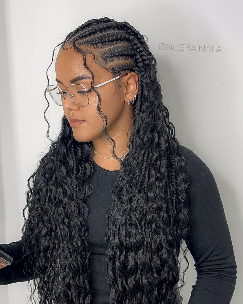 Long black Fulani braids with wavy loose ends and defined cornrow sections.