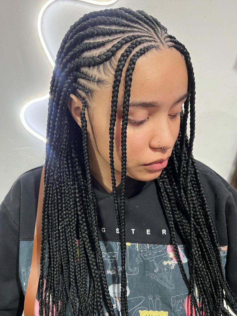 Long straight Fulani braids with a clean center part and smooth finish.