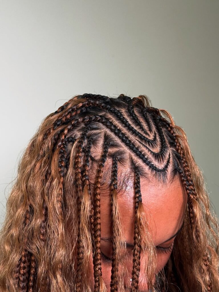 Fulani braids with caramel brown tones and a mix of braids and loose wavy texture.