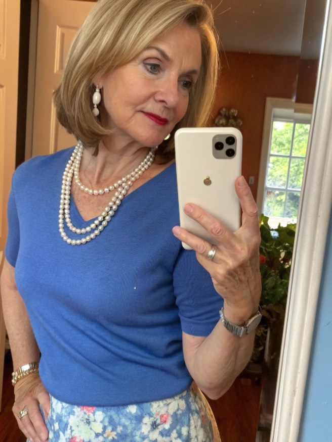 A woman with a sleek golden blonde bob styled with a side part and inwardly curved ends.