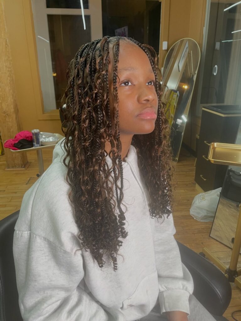 Medium knotless braids with loose curly strands for a boho textured look.