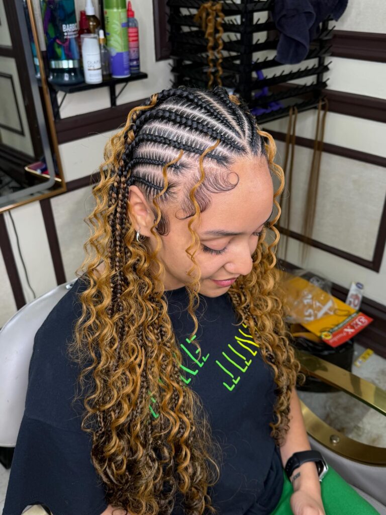 Medium braids with neat cornrows at the top and loose blonde curly ends.