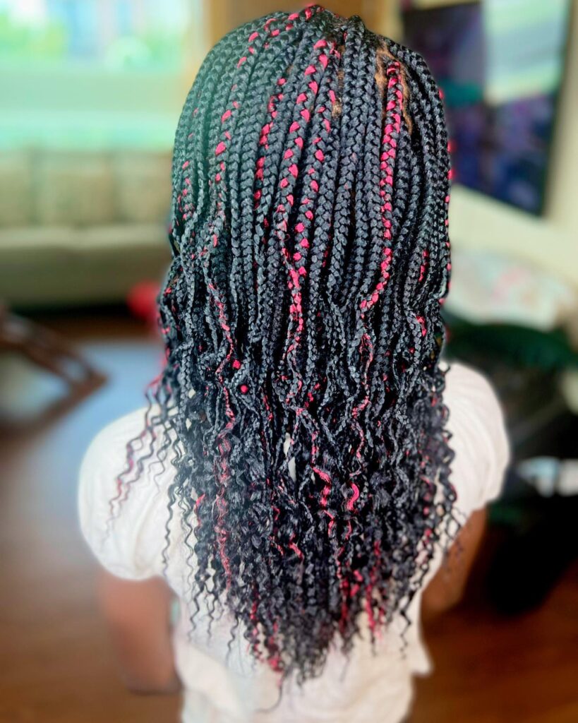Medium braids with curly ends and red highlights blended into black braids.